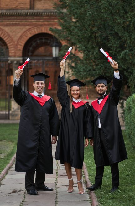 International graduates from celebrating diplomas in graduation robes.